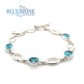 Sterling Silver Bracelet with Oval Cut Blue Topaz - 8"